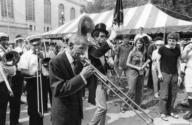Kid Ory in New Orleans 22 April 1971 with the Tuxedo Brass Band in Congo Square for the Jazz and Heritage Festival. Photo by Times-Picayune.